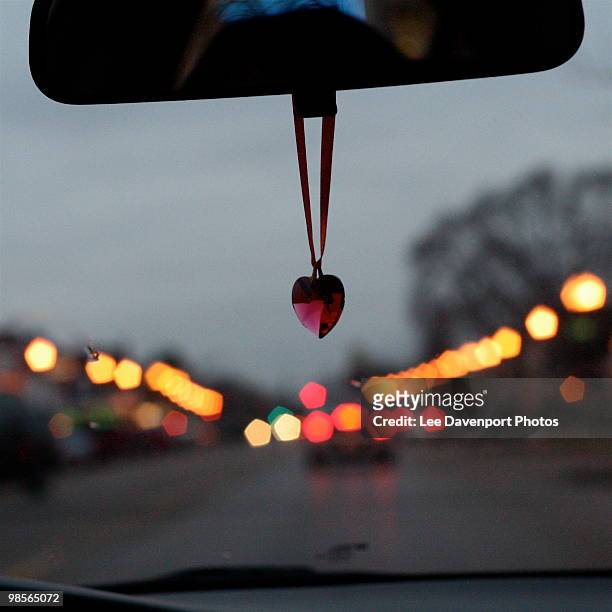 driving a car with bokhe - heart locket stock-fotos und bilder