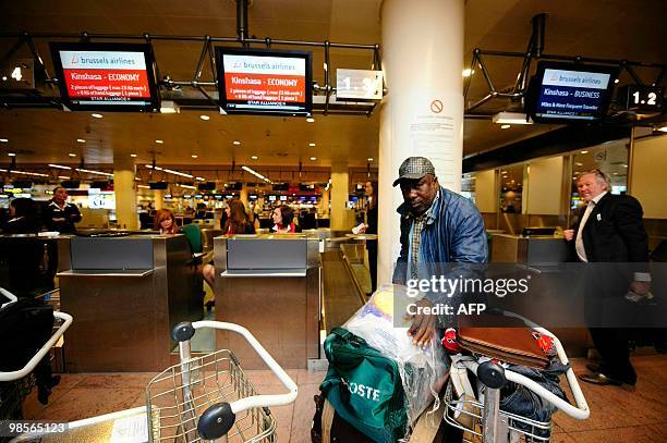 Passenger arrives to complete check-in formalities for a flight bound for Kinshasa, DR Congo at Brussels Airport, in Zaventem on April 20 , 2010. The...