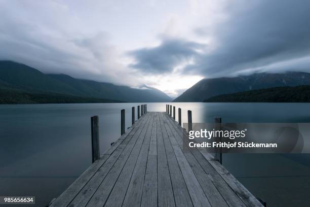a pier at lake rotoiti in new zealand. - nelson lakes national park stock pictures, royalty-free photos & images
