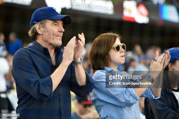 Actor Bryan Cranston and daughter cheer during a MLB game between the Chicago Cubs and the Los Angeles Dodgers on June 26, 2018 at Dodger Stadium in...