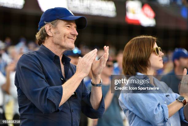 Actor Bryan Cranston and daughter cheer during a MLB game between the Chicago Cubs and the Los Angeles Dodgers on June 26, 2018 at Dodger Stadium in...