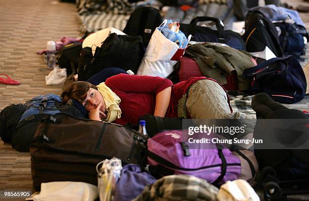 Tourist rests while waiting for the resumption of flights at Incheon International Airport on April 20, 2010 in Incheon, South Korea. Although...