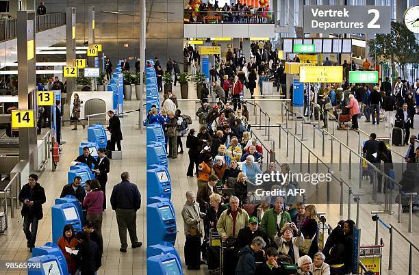 Passengers wait to complete check-in formalities at Schiphol Airport, near Amsterdam on April 20, 2010. Some flights resumed after Three flights...