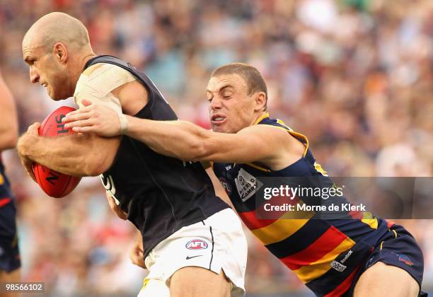 Chris Judd of the Blues is tackled by Simon Goodwin of the Crows during the round four AFL match between the Adelaide Crows and the Carlton Blues at...