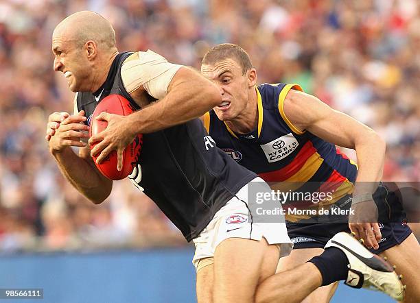Chris Judd of the Blues is tackled by Simon Goodwin of the Crows during the round four AFL match between the Adelaide Crows and the Carlton Blues at...