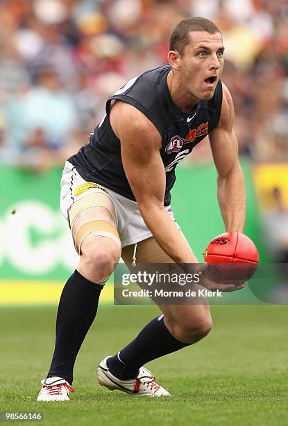 Heath Scotland of the Blues handballs during the round four AFL match between the Adelaide Crows and the Carlton Blues at AAMI Stadium on April 17,...