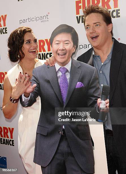 Actress Brooke Shields and actor Brendan Fraser pose with a cardboard cutout of actor Ken Jeong at the premiere of "Furry Vengeance" at Mann Bruin...