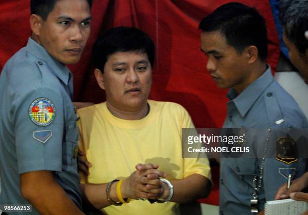 Detained Maguindanao massacre suspect Andal Ampatuan Jnr. Is escorted by policemen back to his detention cell after a press conference at Camp Bagong...