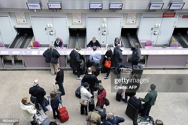 Passengers check in for a flight to Reykjavik in Iceland, at Glasgow Airport, in Scotland, on April 20, 2010. Britain's first flight since European...