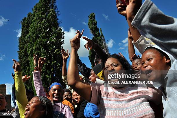 South Africans chant "hero, hero" outside the court in the northwestern town of Ventersdorp on April 6, 2010 as police escort one of the two men...