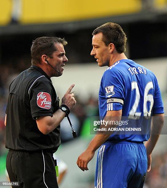 Referee Phil Dowd talks to Chelsea's English defender John Terry during the English Premier League football match between Tottenham Hotspur and...