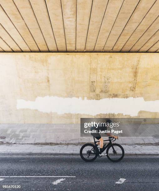 cyclist in underpass - white spandex shorts stockfoto's en -beelden