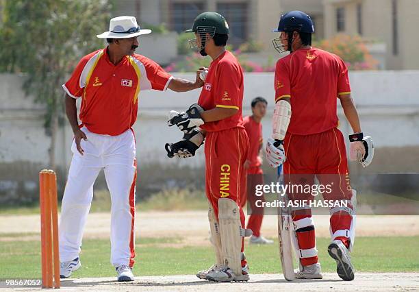 China's Pakistani coach Rashid Khan gives tips to his Chinese cricketers during a training session in Karachi on April 20, 2010. Chinese cricketers...