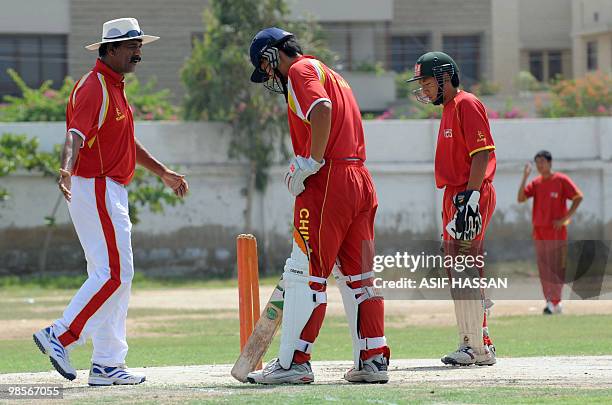 China's Pakistani coach Rashid Khan gives tips to his Chinese cricketers during a training session in Karachi on April 20, 2010. Chinese cricketers...