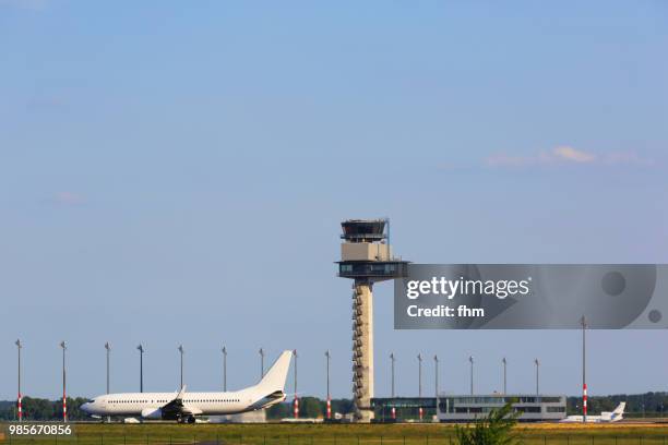 a passenger airplane at schönefeld airport (brandenburg, germany) - flughafen berlin schönefeld stock-fotos und bilder