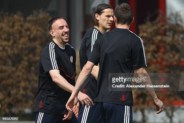 Franck Ribery jokes with his team mates Daniel van Buyten and Miroslav Klose during the Bayern Muenchen training session at Bayern's training ground...