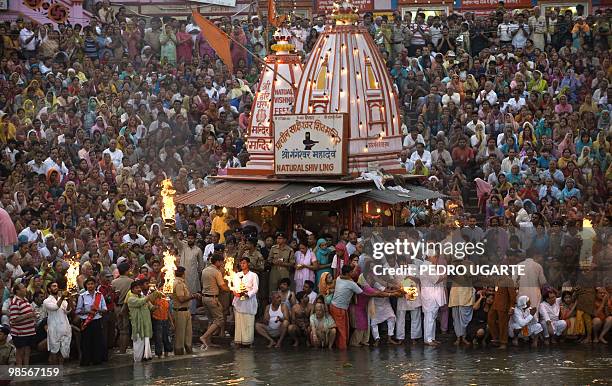 Hindu devotees pray at the banks of river Ganges during the Kumbh Mela festival on April 13, 2010 in Haridwar.The Kumbh Mela, world's largest...