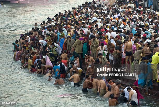 Hindu devotees take a bath on the banks of river Ganges during the Kumbh Mela festival on April 13, 2010 in Haridwar.The Kumbh Mela, world's largest...