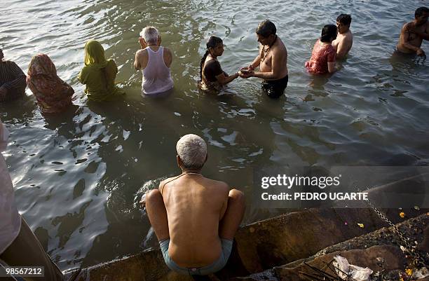 Hindu devotees take a bath on the banks of river Ganges during the Kumbh Mela festival on April 13, 2010 in Haridwar.The Kumbh Mela, world's largest...