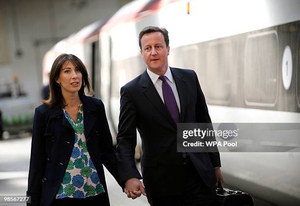 Conservative Party Leader David Cameron and his wife Samantha Cameron walk along a platform before boarding a train bound for Birmingham at Euston...