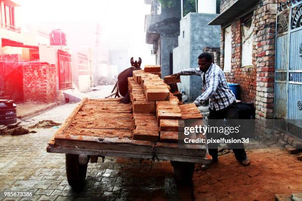 men loading bricks - ice bricks stock pictures, royalty-free photos & images