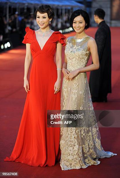 Actresses Zhu Xuan and Fala Chen pose for photographers as they arrive on the red carpet for the Hong Kong Film Awards on April 18, 2010. The annual...