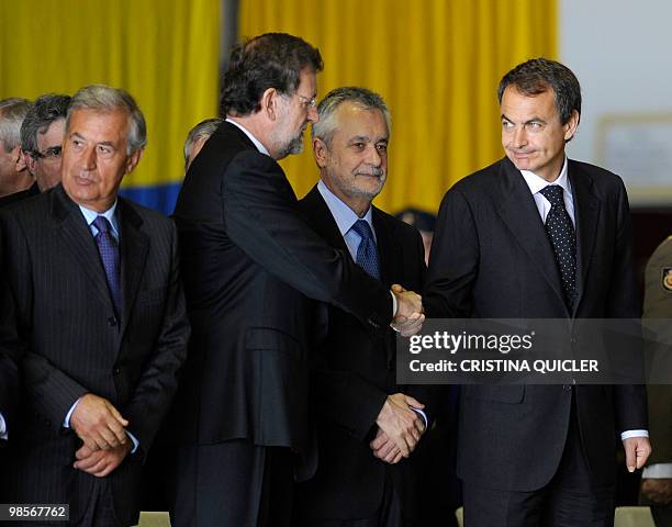 Spanish Prime Minister Jose Luis Rodriguez Zapatero shakes hands with the leader of the PP oppositon party Mariano Rajoy during the funeral of four...
