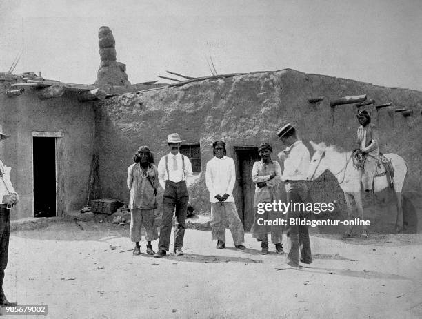 United States of America, descendants of the ancient Aztecs and descendants of the Spanish conquerors in front of an adobe house in New Mexico,...