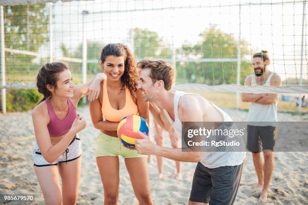 joyful people with volleyball ball - volleyball net stock pictures, royalty-free photos & images