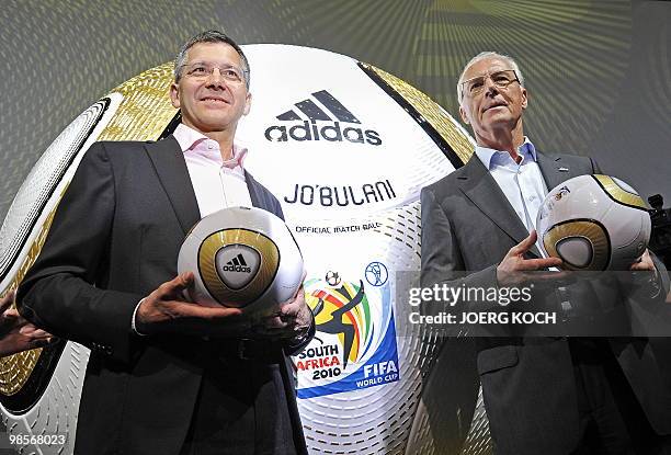 Herbert Hainer , CEO of German sports equipment and clothing maker Adidas and German football legend Franz Beckenbauer pose for photographers with...