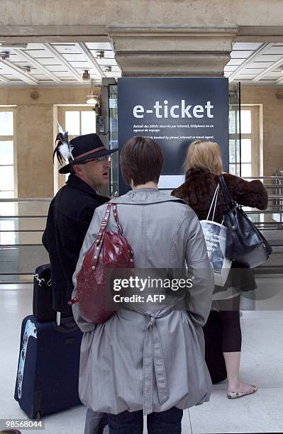 Passengers wait to be issued their e-ticket in Paris gare du Nord railway station, on April 20 to embark aboard a Eurostar train to London. France...