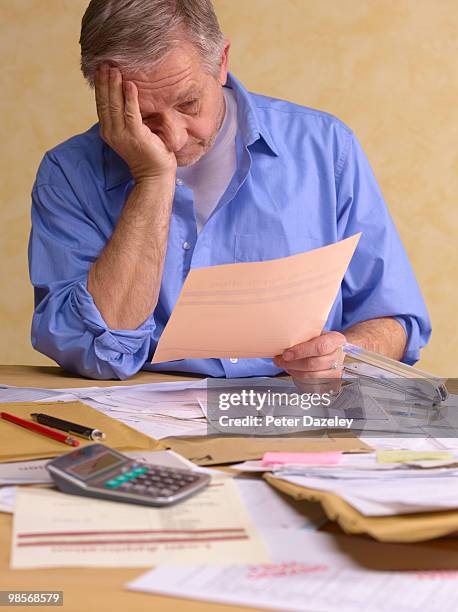 senior man doing tax return - tax return ストックフォトと画像