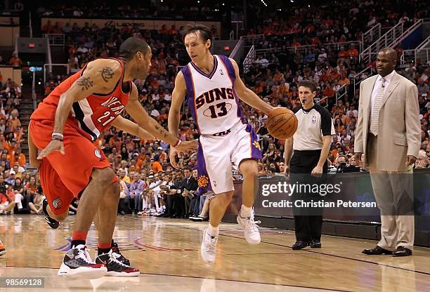 Steve Nash of the Phoenix Suns handles the ball under pressure from Marcus Camby of the Portland Trail Blazers during Game One of the Western...