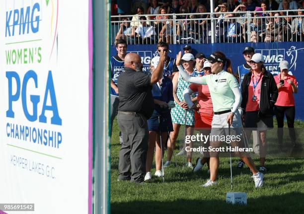 So Yeon Ryu of South Korea gets a high-five from announcer Michael Collins during the player showcase prior to the start of the KPMG Women's PGA...