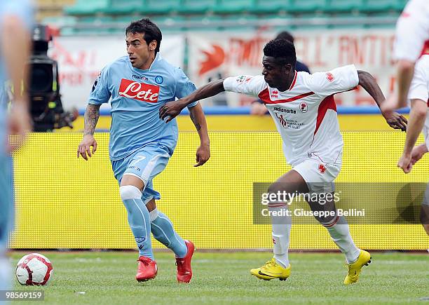 Ezequiel Lavezzi of Napoli and Edgar Alvarez of Bari in action during the Serie A match between AS Bari and SSC Napoli at Stadio San Nicola on April...