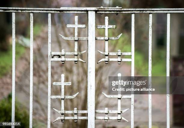 Cast-iron crosses pictured on the entry gate to the evangelical cemetery in the Deichhorst district of Delmenhorst, Germany, 26 January 2018. The...