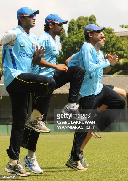 Sri Lankan cricketers Chinthaka Jayasinghe , Chanaka Welegedara and Suraj Randiv warm up at a practice session at the P.Sara Stadium in Colombo on...