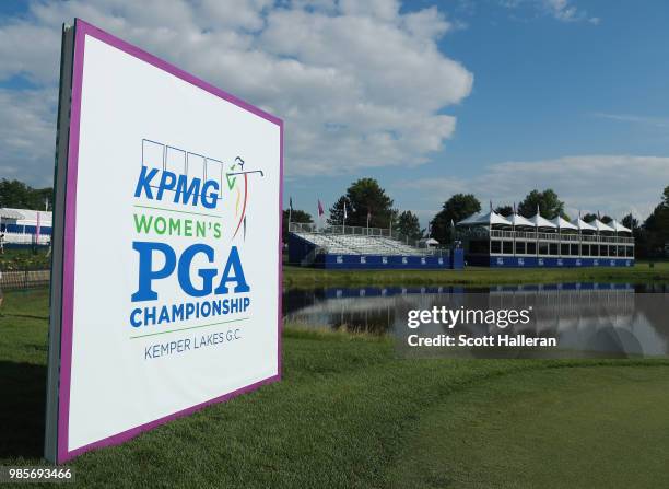 Course signage is seen behind the 18th green during the player showcase prior to the start of the KPMG Women's PGA Championship at Kemper Lakes Golf...