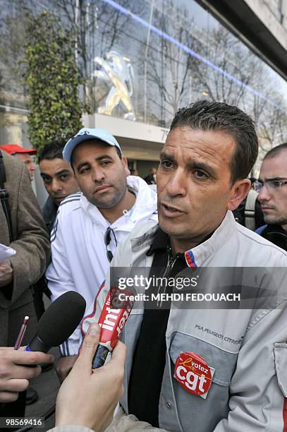 Younes Mekideche , French CGT trade-union representative from French car maker PSA Peugeot Citroen answers to journalists as the workers demonstrate...