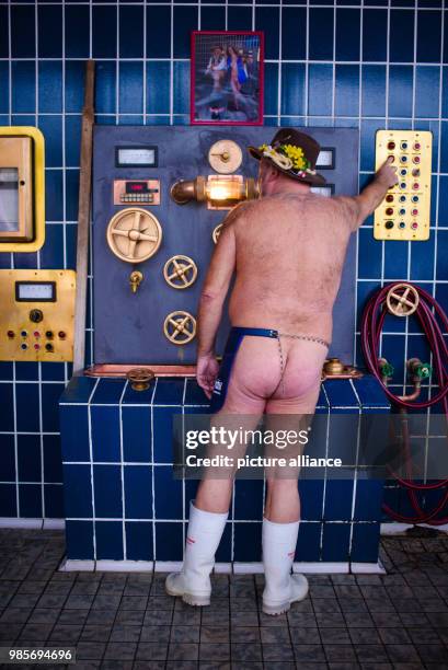 Beer brewer Juergen Hopf standing wearing only an apron in the southern wing of the Lang-Braeu Brewery in Wunsiedel, Germany, 19 December 2017....