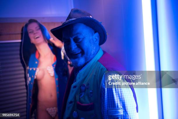 Beer brewer Juergen Hopf standing next to a cardboard advertisement showing a lightly clad woman in the southern wing of the Lang-Braeu Brewery in...