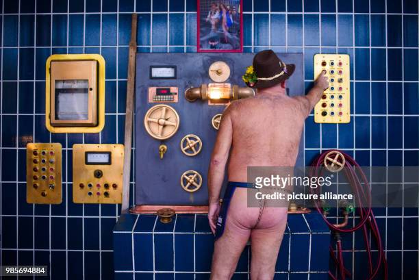 Beer brewer Juergen Hopf standing wearing only an apron in the southern wing of the Lang-Braeu Brewery in Wunsiedel, Germany, 19 December 2017....