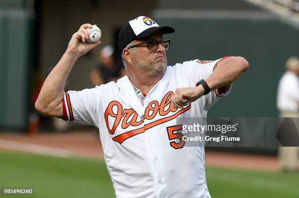 Retired MLB Umpire Dale Scott throws out the first pitch before the game between the Baltimore Orioles and the Seattle Mariners at Oriole Park at...