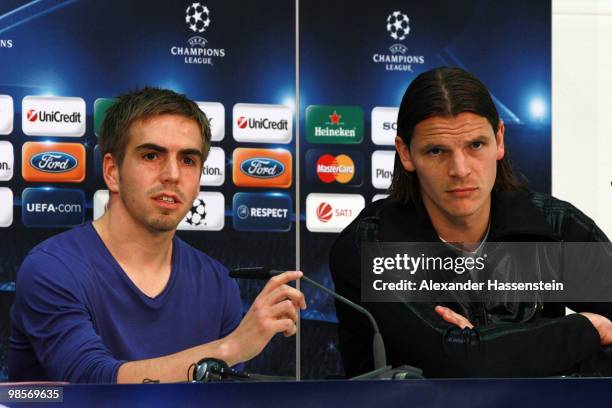 Philipp Lahm looks on with his team mate Daniel van Buyten during a press conference on April 20, 2010 in Munich, Germany. Bayern Muenchen will play...