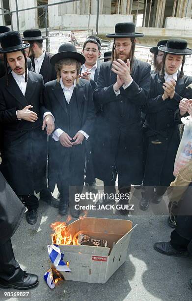Anti-Zionist Ultra Orthodox Jews burn the Israel flag during a demonstration against the current celebrations for the 62nd anniversary of Israel's...