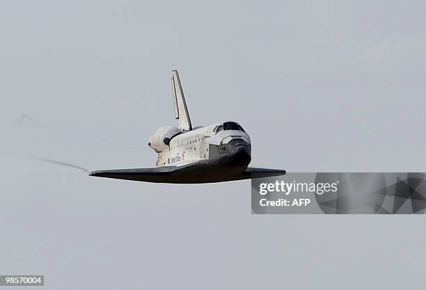 The space shuttle Discovery approaches the landing strip April 20, 2010 at Kennedy Space Center in Florida at the end of a 15-day mission to the...