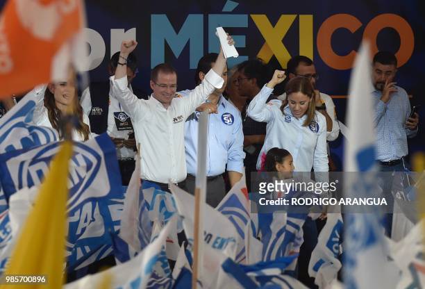 Mexico's presidential candidate Ricardo Anaya , standing for the "Mexico al Frente" coalition of the PAN-PRD-Movimiento Ciudadano parties, raises his...