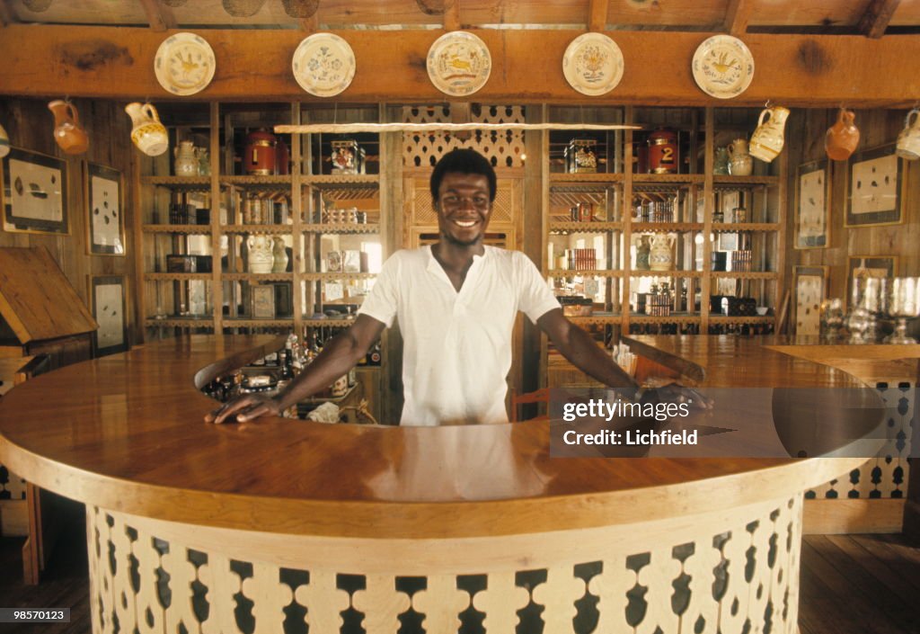 Basil Charles behind the bar at Basil's on Mustique, in the West ...