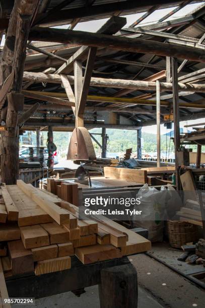 Lengths of salvaged huon pine wait to be milled at Wilderness Woodworks, a specialty timber mill in Strahan, Tasmania. The tree is native to south...