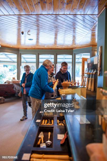 Tourists inside Wilderness Woodworks gallery, a mill specializing in Huon Pine in Strahan, Tasmania. The tree is native to south west Tasmania and...